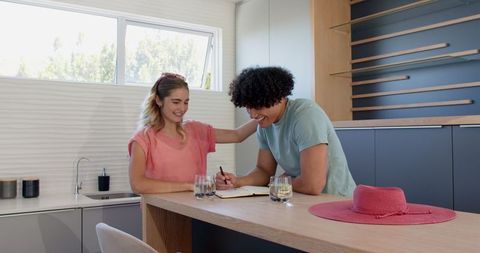 Young Couple Discussing Plans in Modern Kitchen
