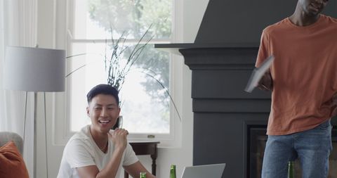 Modern Living Room with Men Engaging in Technology and Leisure