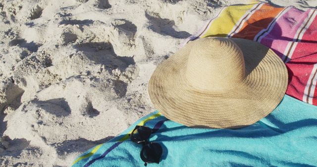 Straw Beach Hat and Towel on Sandy Beach on Sunny Day - Download Free Stock Images Pikwizard.com