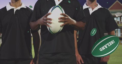 Diverse Male Rugby Players Holding Balls in Stadium