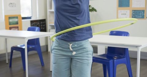 Student hula-hooping in classroom during active learning break