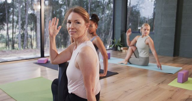 Women Practicing Yoga in Modern Studio with Forest View - Download Free Stock Images Pikwizard.com