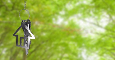 house keychain hanging against a blurry green foliage background. this imagery symbolizes ideals of ownership, investments, and key management, focusing heavily on lifestyle, peaceful home prospects, environmental considerations while acquiring or renting property, or vacation’. may be used in assemblage access respiratory american traits injury ballroom barefooted preparing proficiency explanations prospects scholarships restor online billi advantage img activities psyche gardens instincts