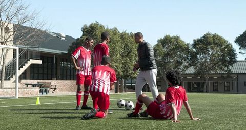 Teen Soccer Team Training Under Coach's Guidance