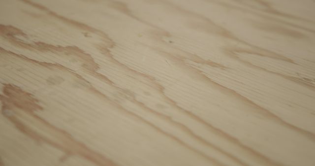 Close-up of light wood surface showcasing its natural grain pattern, suitable for use as a background or texture in design projects, advertisements, and presentations. Ideal for carpentry, woodworking themes, and natural material projects.