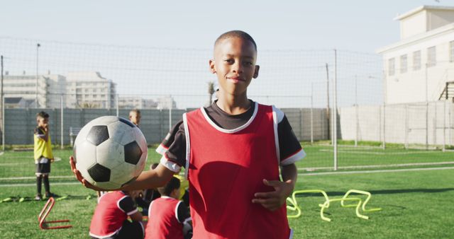 Young Boy Holding Soccer Ball on Training Field in Summer - Download Free Stock Images Pikwizard.com