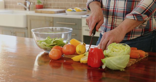 Person preparing fresh vegetables for salad in modern kitchen - Download Free Stock Images Pikwizard.com