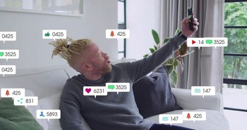 Influencer reaching for selfie during livestream on sofa with social media notifications