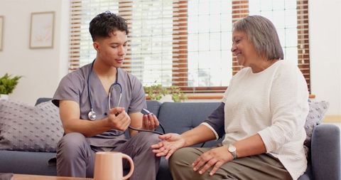 Nurse Measuring Blood Pressure of Senior Woman at Home