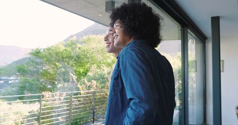 Happy Father and Son Enjoy Scenic View from Balcony