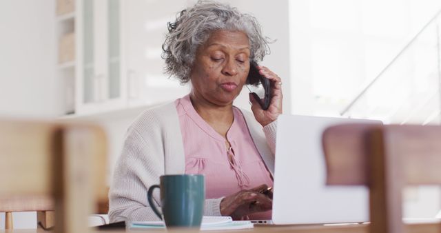 Senior Woman Using Laptop and Talking on Phone at Home - Download Free Stock Images Pikwizard.com