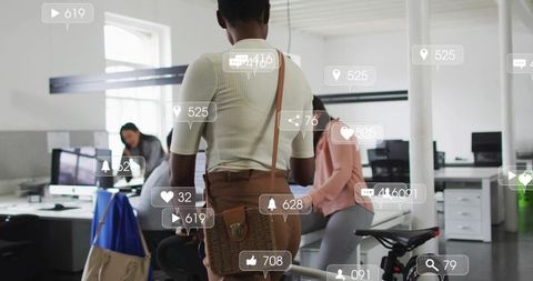 Female professional receiving social media notifications in open-plan coworking office