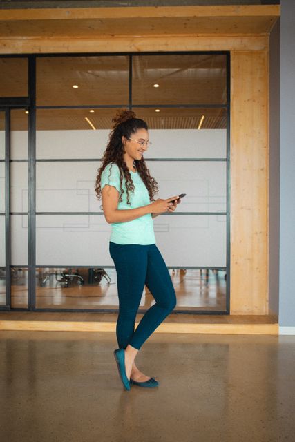 Smiling Creative Businesswoman Using Smartphone in Office - Download Free Stock Images Pikwizard.com