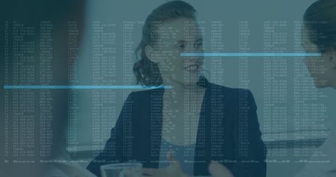 Businesswomen Collaborating with Data Overlay at Conference Table