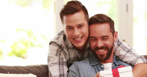 Father and Son Bonding Over Gift in Bright Living Room