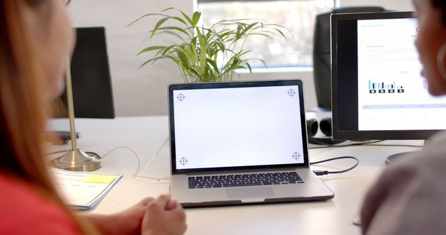 Two People Collaborating at Office Desk with Laptop and Documents - Download Free Stock Images Pikwizard.com