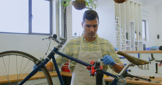 Young Man Performing Bicycle Maintenance in Workshop - Download Free Stock Images Pikwizard.com