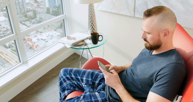 Young Man Relaxing with Smartphone at Home - Download Free Stock Images Pikwizard.com