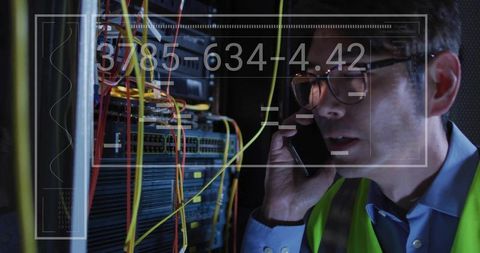 Korean engineer inspecting server rack in datacenter with hud diagnostics