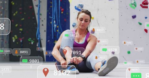 Focused woman preparing for indoor rock climbing