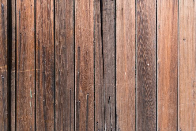 Close-up of rustic wooden paneling showcasing natural grain textures. This image can be used as a background for websites, promotional materials, or digital media projects. Ideal for construction, interior design, or nature-related content, providing a natural and earthy visual appeal.