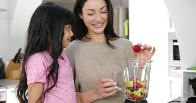 Mother and Daughter Preparing Healthy Fruit Smoothie in Kitchen - Download Free Stock Images Pikwizard.com