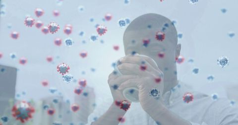 Concept of health: man drinking coffee surrounded by virus particles