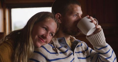 Cozy Couple Enjoying Serene Morning in Log Cabin Retreat