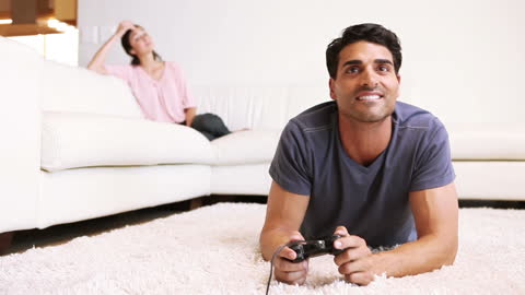 Man Enthusiastically Playing Video Games on Soft Carpet