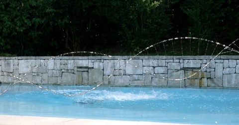Elegant Water Jet Display in Tranquil Backyard Pool Area