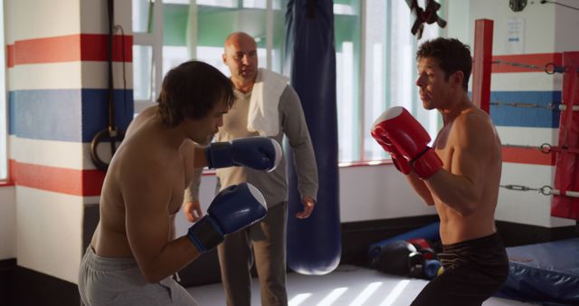 Two Men Sparring in a Boxing Gym with Coach Supervising - Download Free Stock Images Pikwizard.com