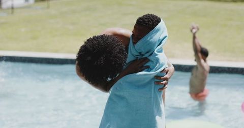 Mother Drying Son with Towel by Poolside on Sunny Day - Download Free Stock Images Pikwizard.com