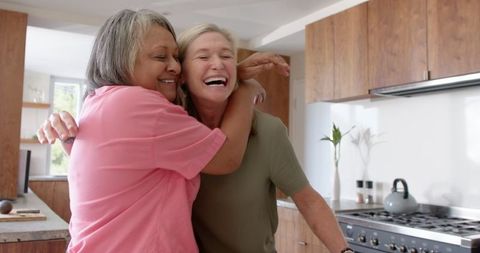 Loving Mother-Daughter Hug in Warmly Lit Kitchen