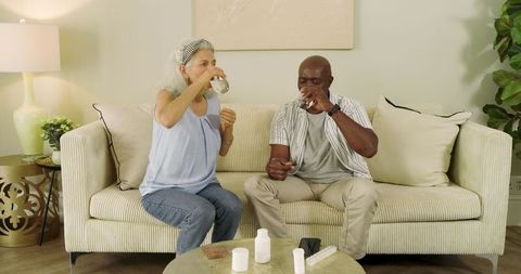 Senior couple practicing daily health ritual with medication