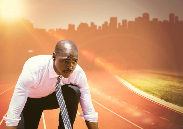 Image shows a businessman in a shirt and tie at the starting line of a track with a city skyline in the background. This could be used to illustrate concepts of competition, career goals, and professional determination. Ideal for presentations, advertisements, or articles about business motivation, work-life balance, and ambition.