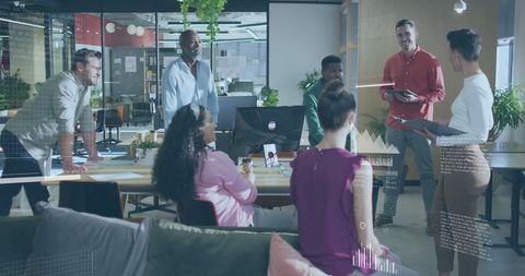 Diverse office team analyzing financial data with innovative technology