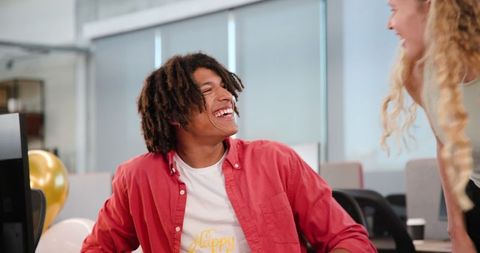 Colleagues Sharing a Light-Hearted Moment in the Office