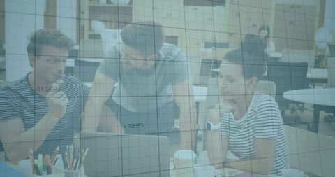 Young team collaborating behind blue-tinted glass grid overlay in modern open-plan office