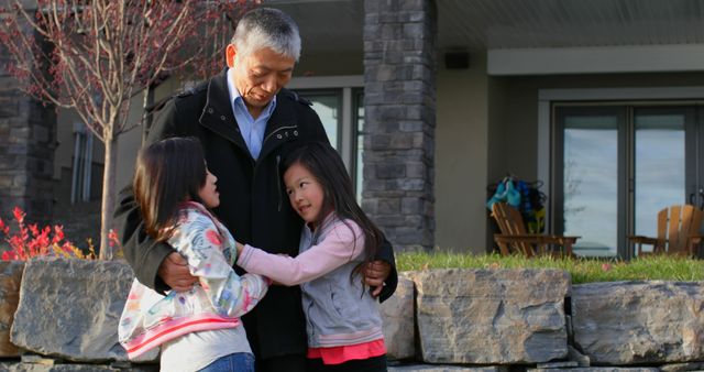 Grandfather Embracing Granddaughters Outdoors in Cozy Moment - Download Free Stock Images Pikwizard.com