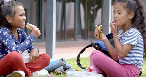 Joyful Young Girls Enjoying Outdoor School Lunch Together