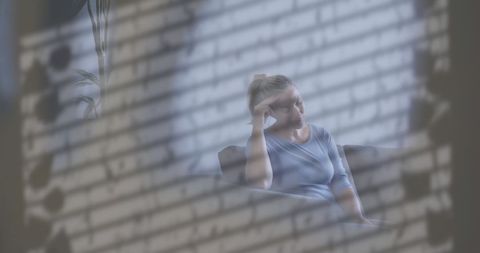 Reflective woman in contemplative mood in cozy home