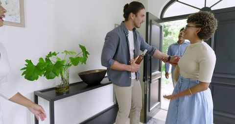 Guests Arriving with Smiles and Greeting Tightly with Host