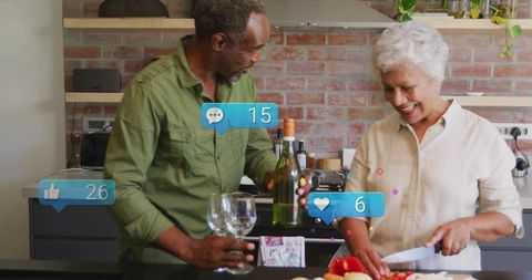 Senior couple joyfully cooking in modern home kitchen