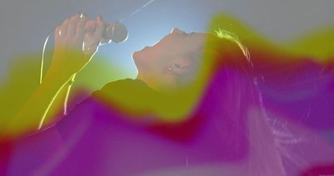 Female Vocalist Performing Energized Concert with Psychedelic Lighting
