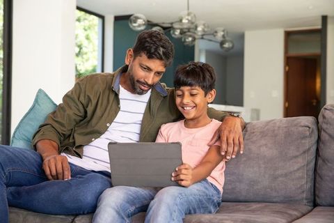 Indian Father and Son Bonding Over Tablet at Home