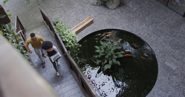 Colleagues Walking by Outdoor Water Garden with Laptop and Relaxing Environment - Download Free Stock Images Pikwizard.com