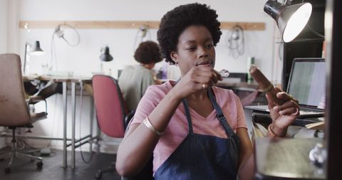 African American Jeweller Crafting in Workshop