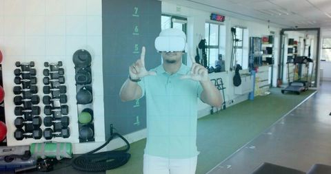 Wearing vr headset framing virtual interface in gym for immersive fitness training