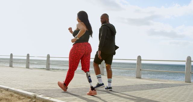 Woman with Prosthetic Leg Jogging on Seaside Promenade - Download Free Stock Images Pikwizard.com