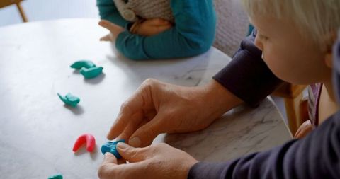 Father and Children Crafting with Colorful Clay